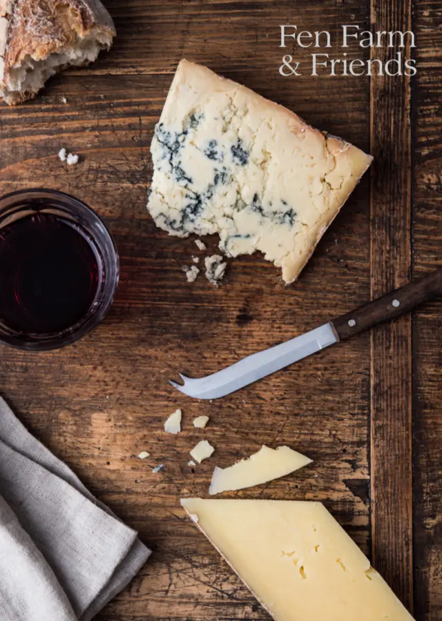 Fen Farm & Friends promotional poster with cheese, wine and a knife on a wooden board